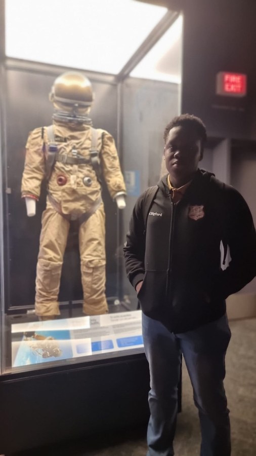 Jayvaughn Bigford with an astronaut suit exhibit